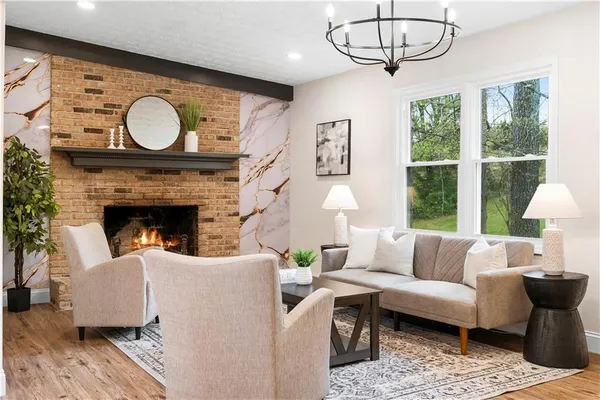 a living room with furniture a table and a large window