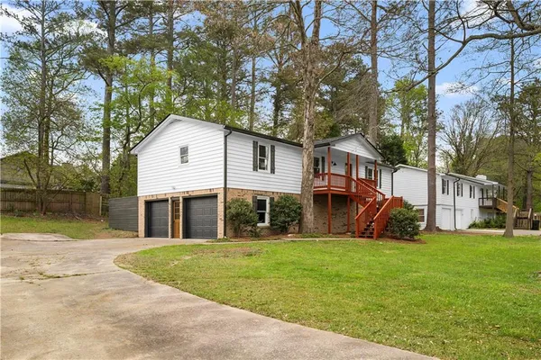 a front view of house with yard and trees