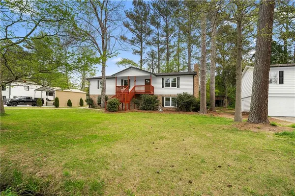 a view of a house with a yard and garage