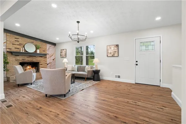 a living room with furniture a window and wooden floor