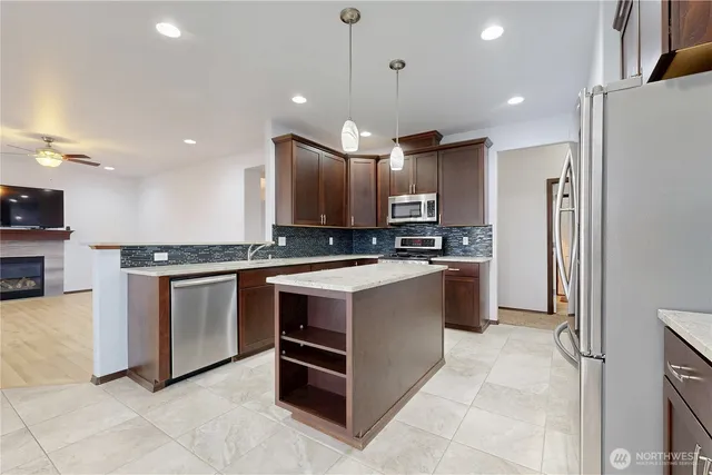 a kitchen with a refrigerator a sink and cabinets