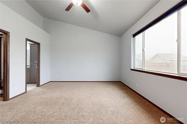 an empty room with closet and mirror
