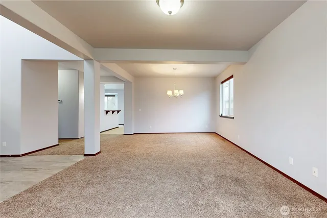 an empty room with a empty space and windows