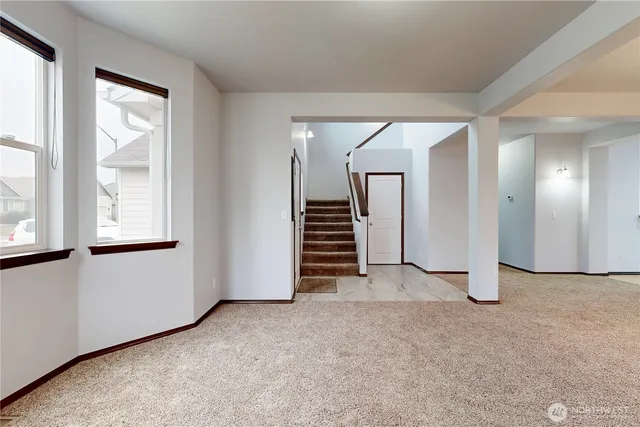 an empty room with windows and closet