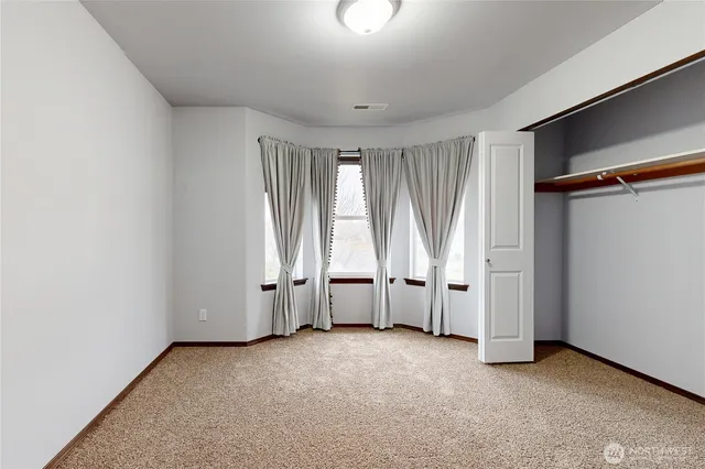 a view of an empty room and closet