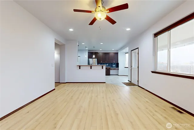 a kitchen with stainless steel appliances granite countertop a stove refrigerator and a sink