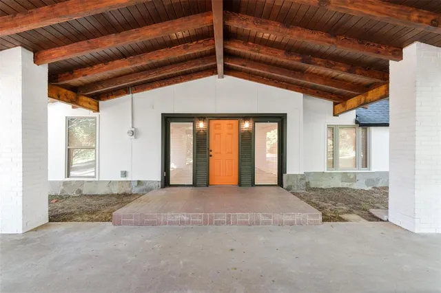 a view of a room with wooden floor and windows