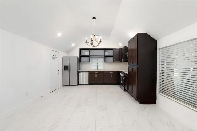 a kitchen with stainless steel appliances a refrigerator and a sink