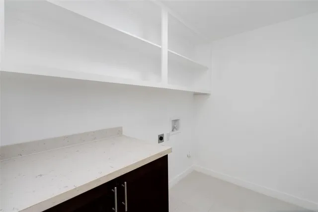 an empty room with windows and ceiling fan