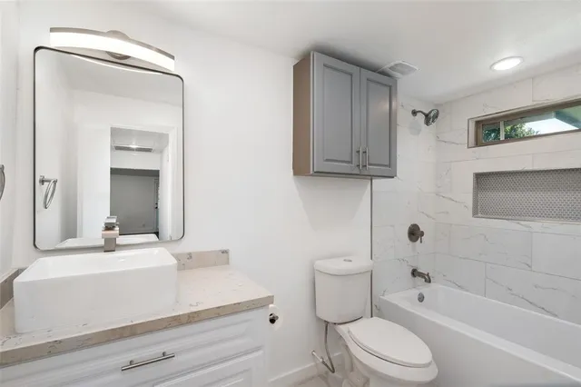 an aerial view of residential house with outdoor space and trees all around