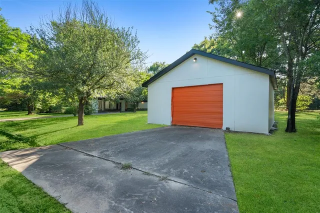 a view of backyard of house with green space