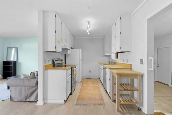 a kitchen with a sink a stove and a refrigerator