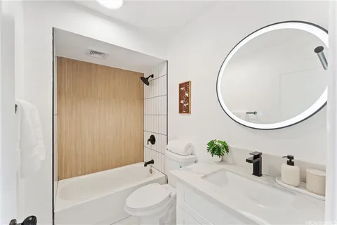 a bathroom with a sink a toilet and a mirror