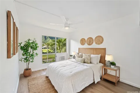 a bedroom with a bed and a potted plant