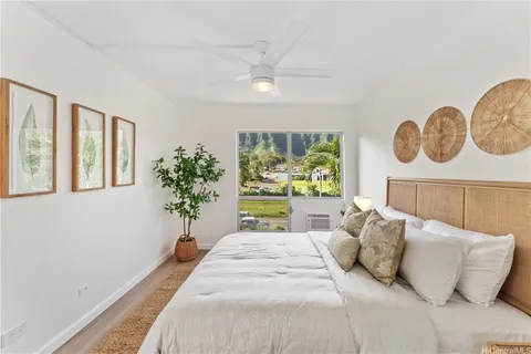 a bedroom with a bed and painting on the wall