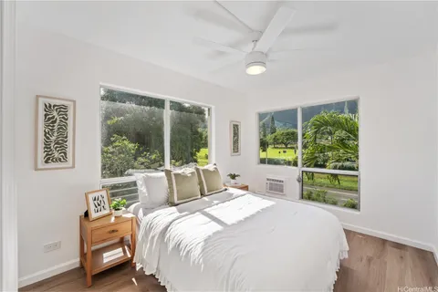 a bedroom with a bed and a large window