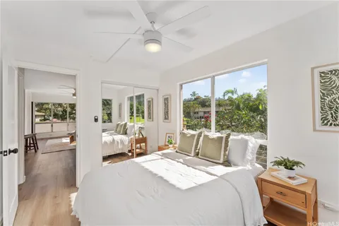 a bedroom with a bed and a large window