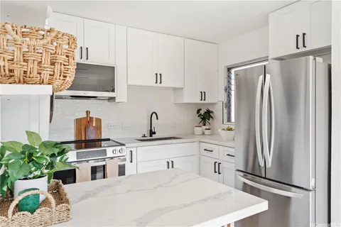 a kitchen with stainless steel appliances a refrigerator sink and stove