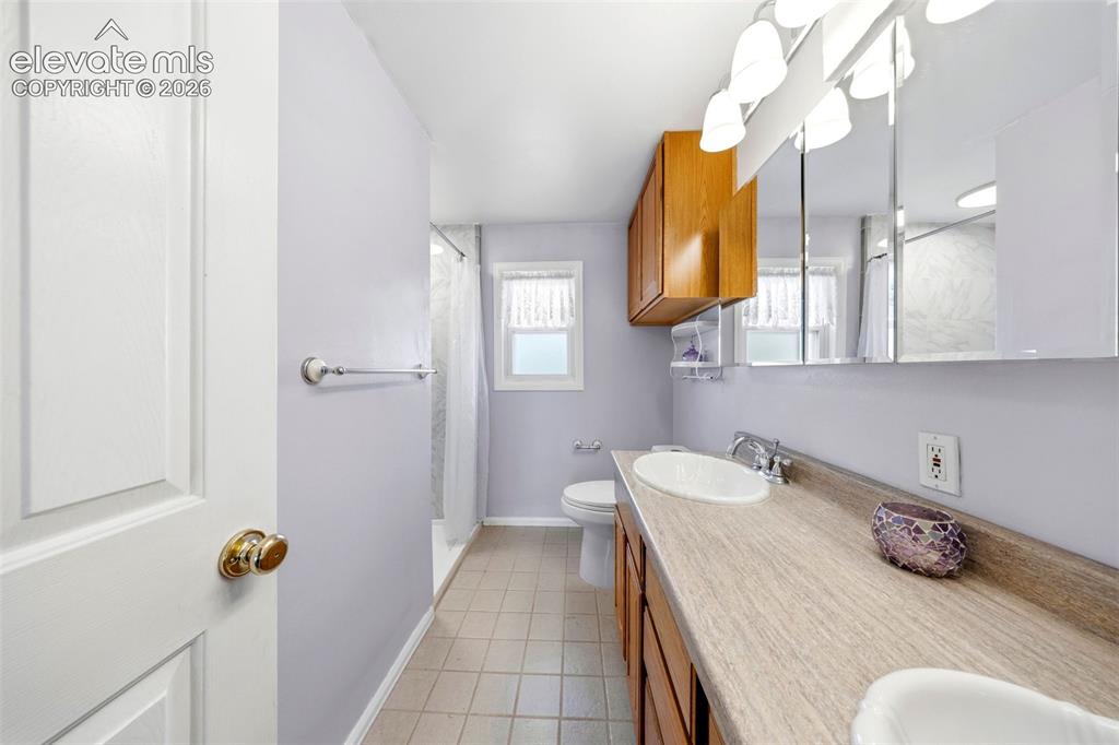 13075 Blaney Road South Peyton, CO 80831 - Photo 18 of 40 Bathroom vanity with dual oval sinks and cabinetry
