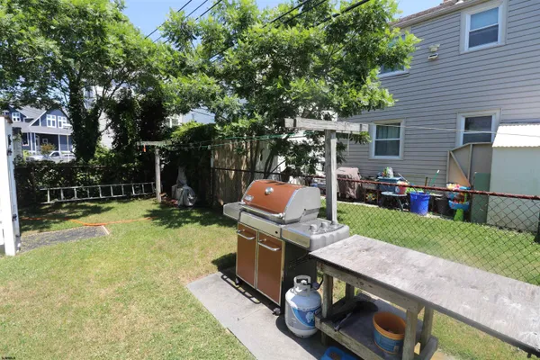 a backyard of a house with barbeque oven and a fountain