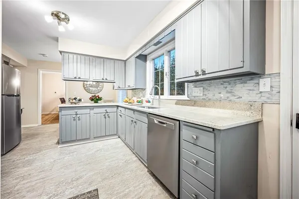 a kitchen with a sink window and cabinets