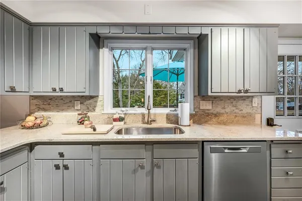 a kitchen with a sink cabinets and window