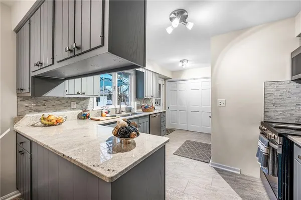 a kitchen with a sink a stove and cabinets