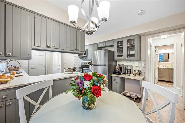 a kitchen with refrigerator cabinets and a dining table