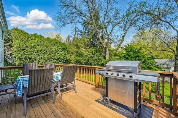 a view of a deck with two chair and wooden floor