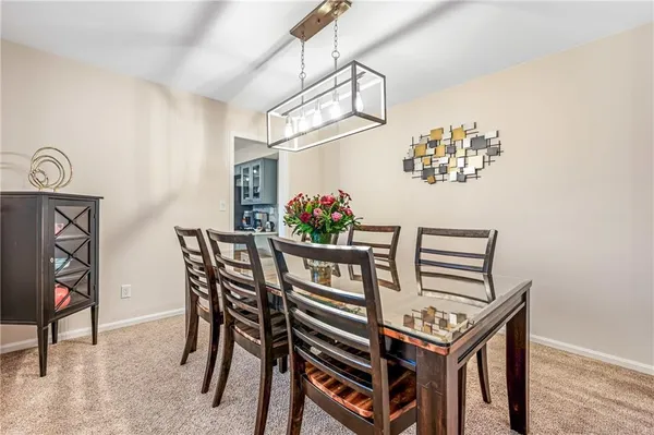 a view of a dining room with furniture and a chandelier