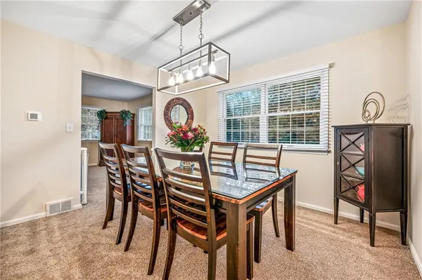 a dining room with furniture and window
