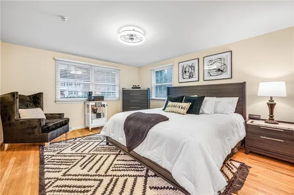 a bedroom with a bed couch and a window