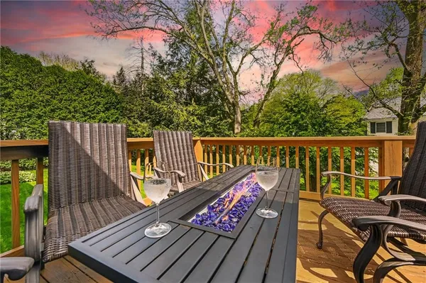 a view of a balcony with wooden floor and outdoor seating
