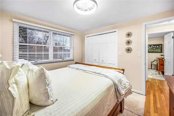 a bed sitting in a bedroom next to a window