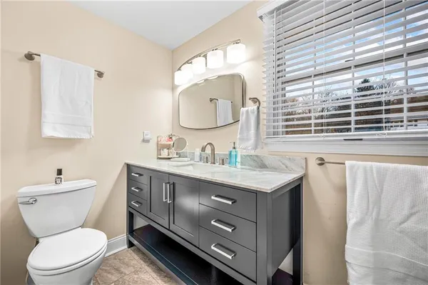 a bathroom with a toilet a sink and a mirror