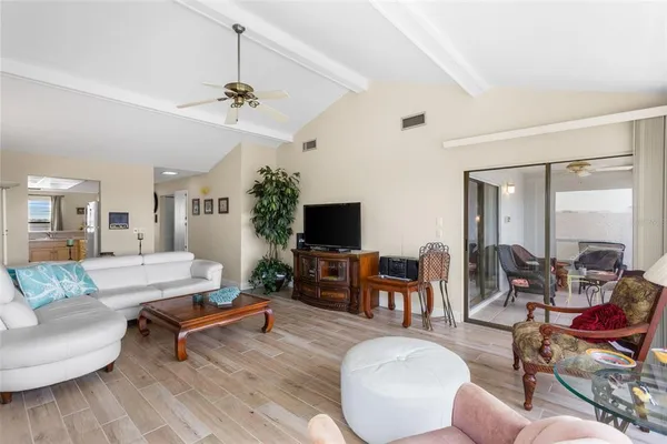 a living room with furniture a rug and a window
