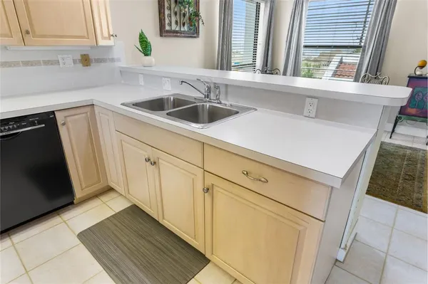 a kitchen with a refrigerator a stove and a sink
