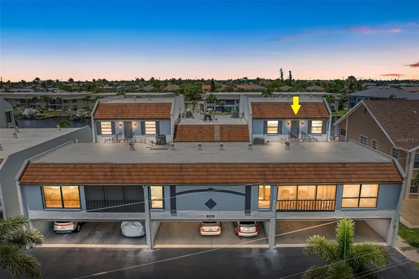 an aerial view of residential houses with outdoor space and swimming pool