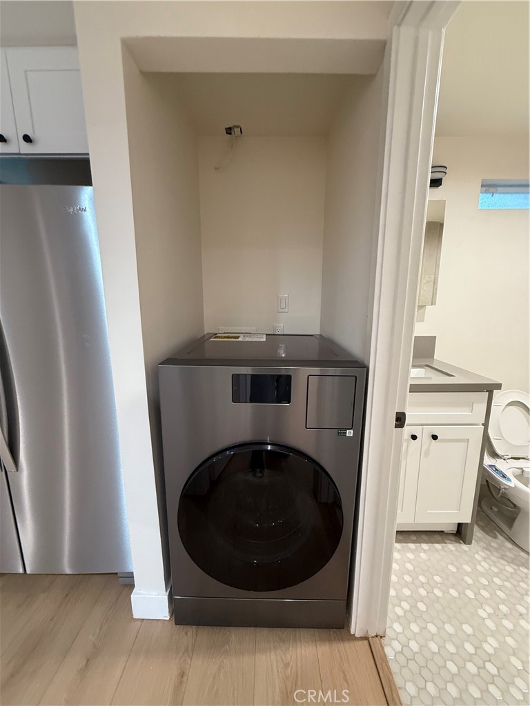 6538 Kelvin Avenue Winnetka, CA 91306 - Photo 12 of 20 a utility room with washing machine and a view of bedroom