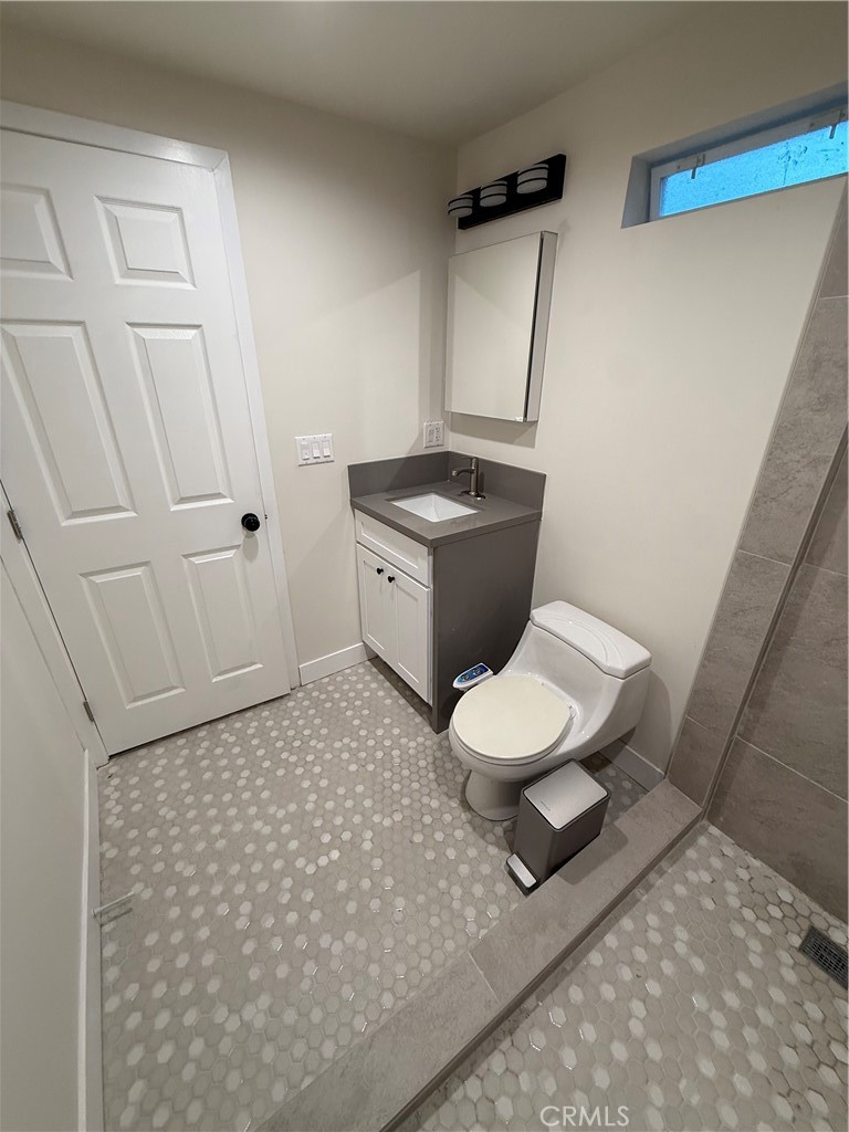 6538 Kelvin Avenue Winnetka, CA 91306 - Photo 15 of 20 a bathroom with a granite countertop toilet and a sink