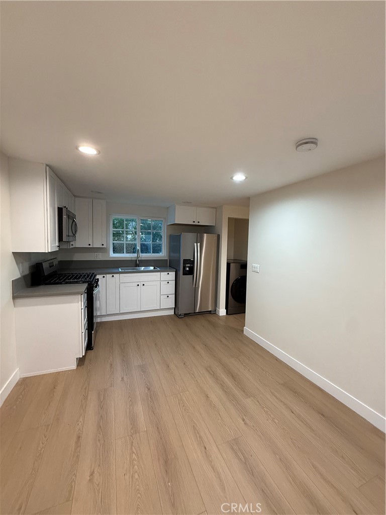 6538 Kelvin Avenue Winnetka, CA 91306 - Photo 6 of 20 a view of a kitchen with a sink and a refrigerator
