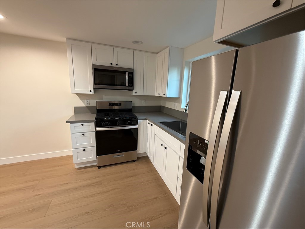 6538 Kelvin Avenue Winnetka, CA 91306 - Photo 9 of 20 a kitchen with stainless steel appliances a refrigerator stove and microwave