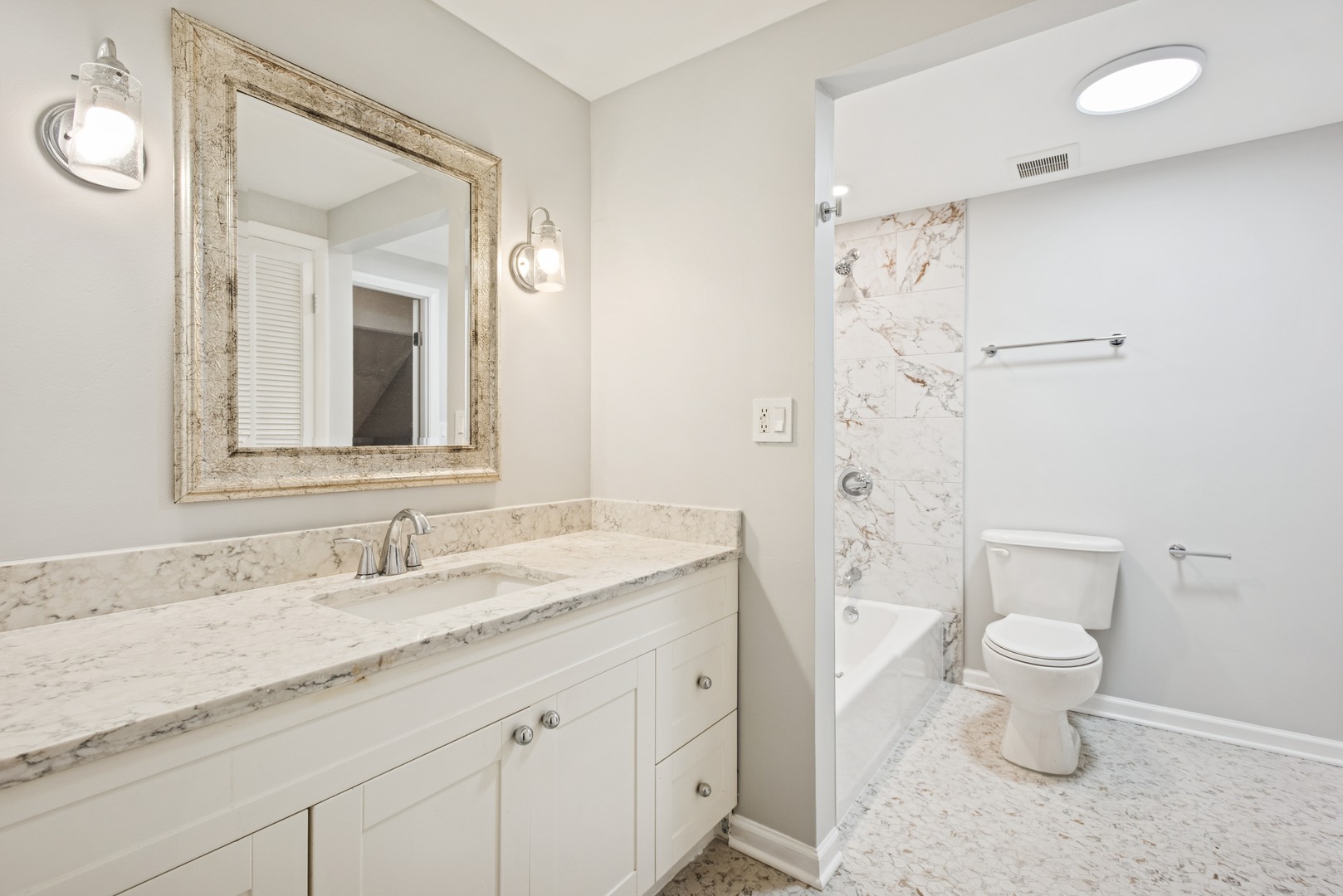 2 Croyden On Duxbury Rolling Meadows, IL 60008 - Photo 12 of 24 a bathroom with a granite countertop sink a toilet and a mirror