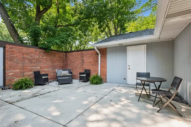 a backyard of a house with yard and outdoor seating