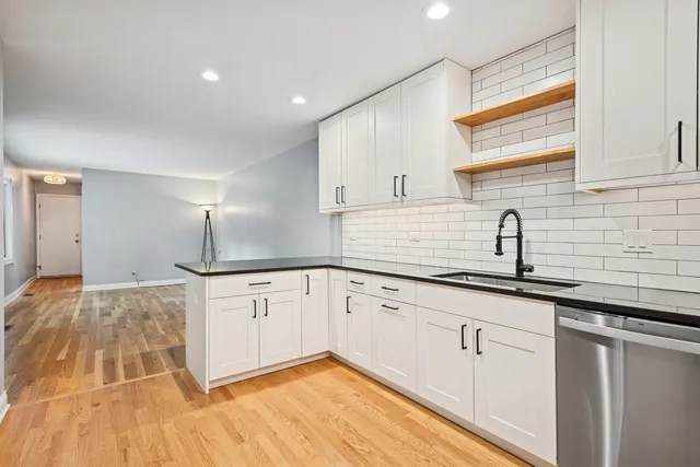 a kitchen with granite countertop white cabinets and white appliances