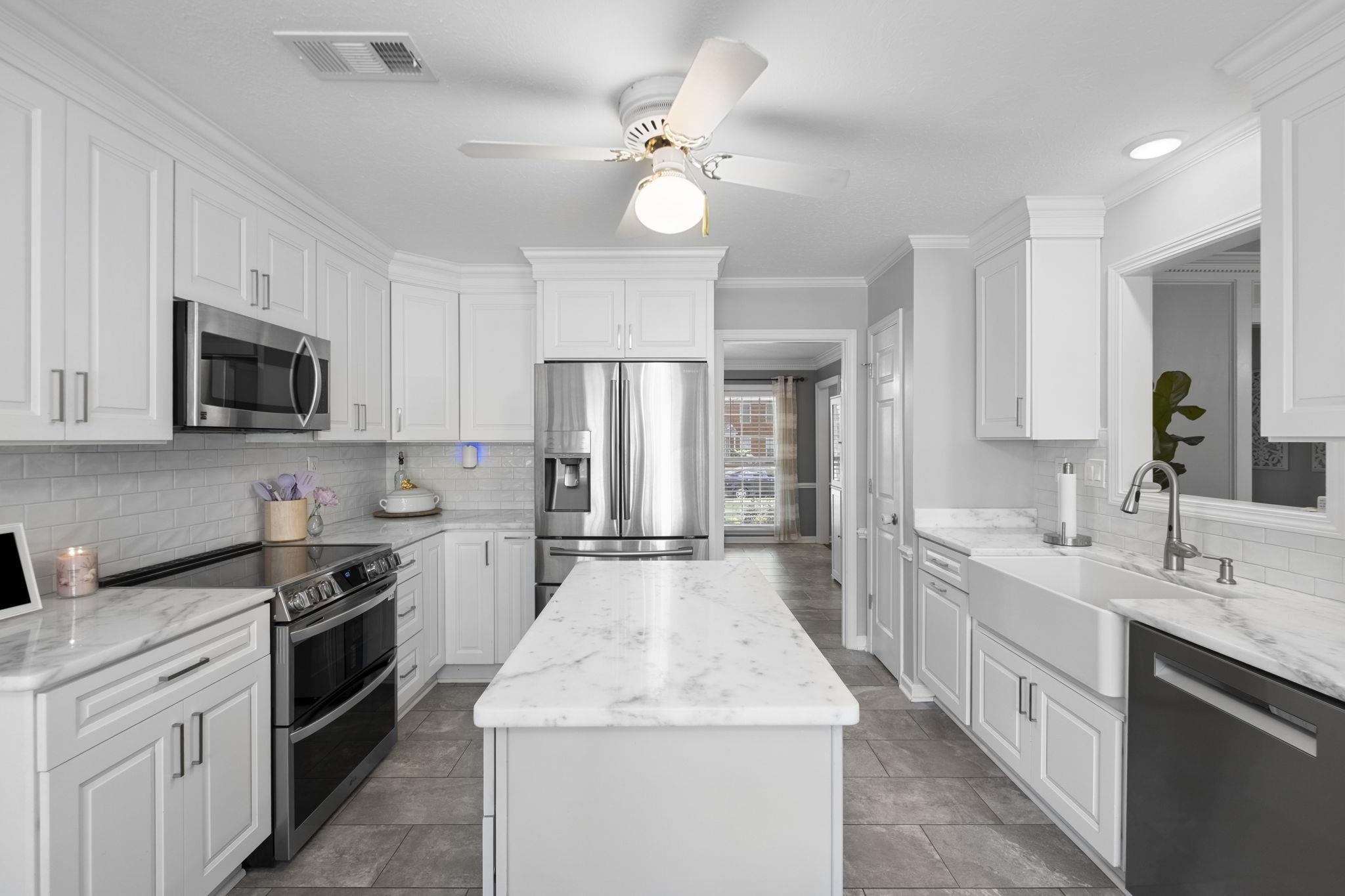 3353 Beaver Run Cove North Collierville, TN 38017 - Photo 12 of 34 a kitchen with a sink stove and microwave