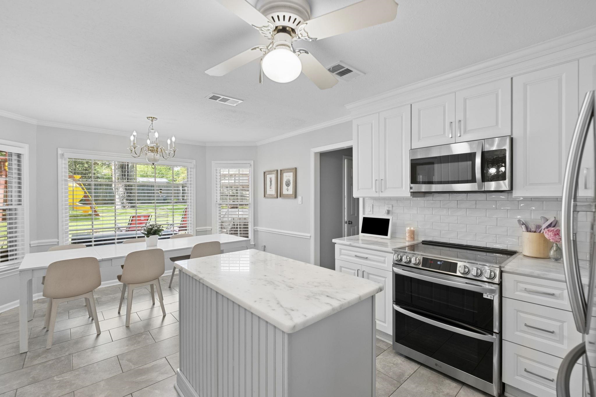 3353 Beaver Run Cove North Collierville, TN 38017 - Photo 13 of 34 a kitchen with a stove a microwave and white cabinets