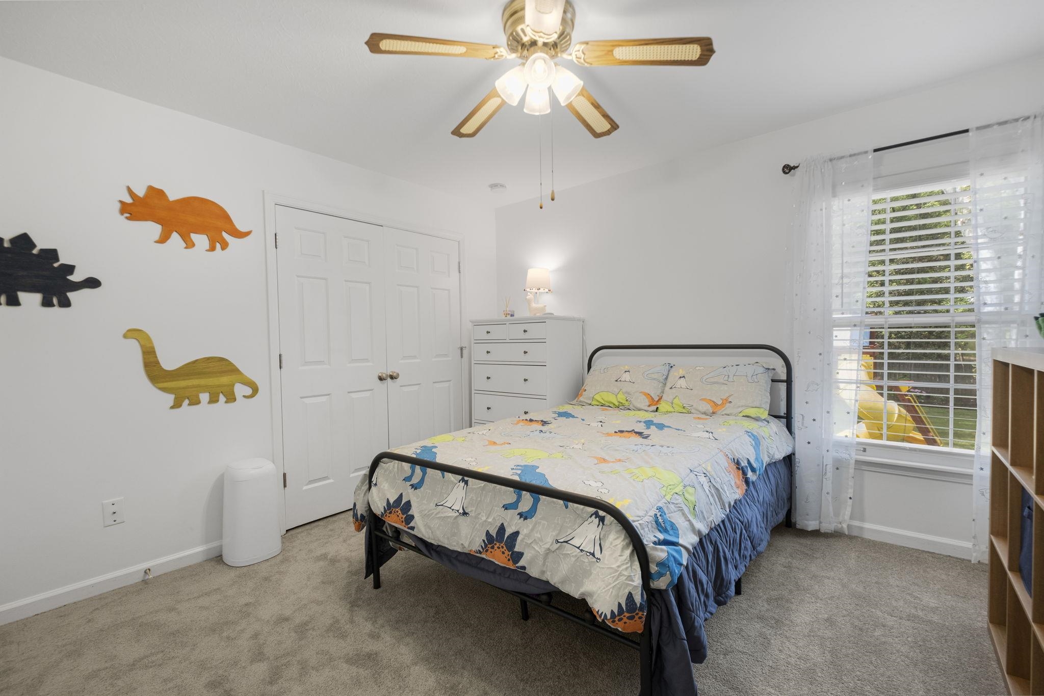 3353 Beaver Run Cove North Collierville, TN 38017 - Photo 24 of 34 a bedroom with a bed and a chandelier
