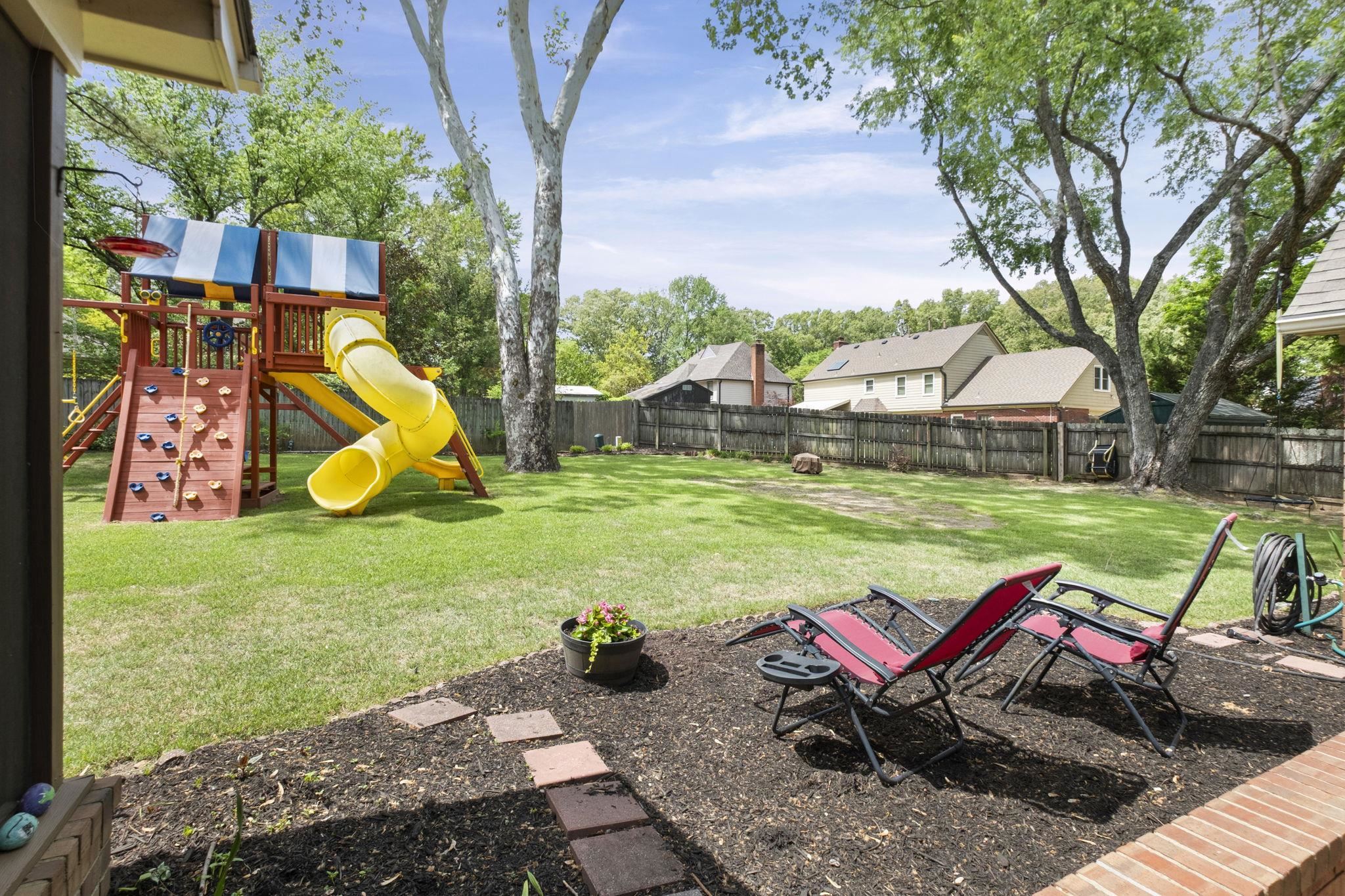 3353 Beaver Run Cove North Collierville, TN 38017 - Photo 30 of 34 a view of a backyard with table and chairs and a fire pit