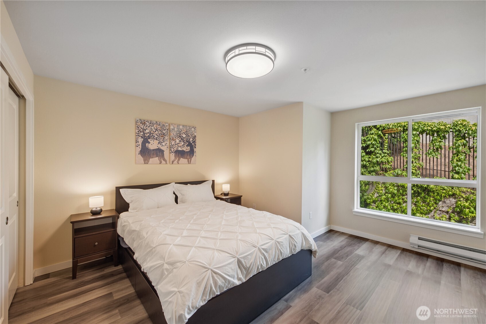 108 5th Avenue South, Unit 506 Seattle, WA 98104 - Photo 11 of 17 a bedroom with a bed and a large window